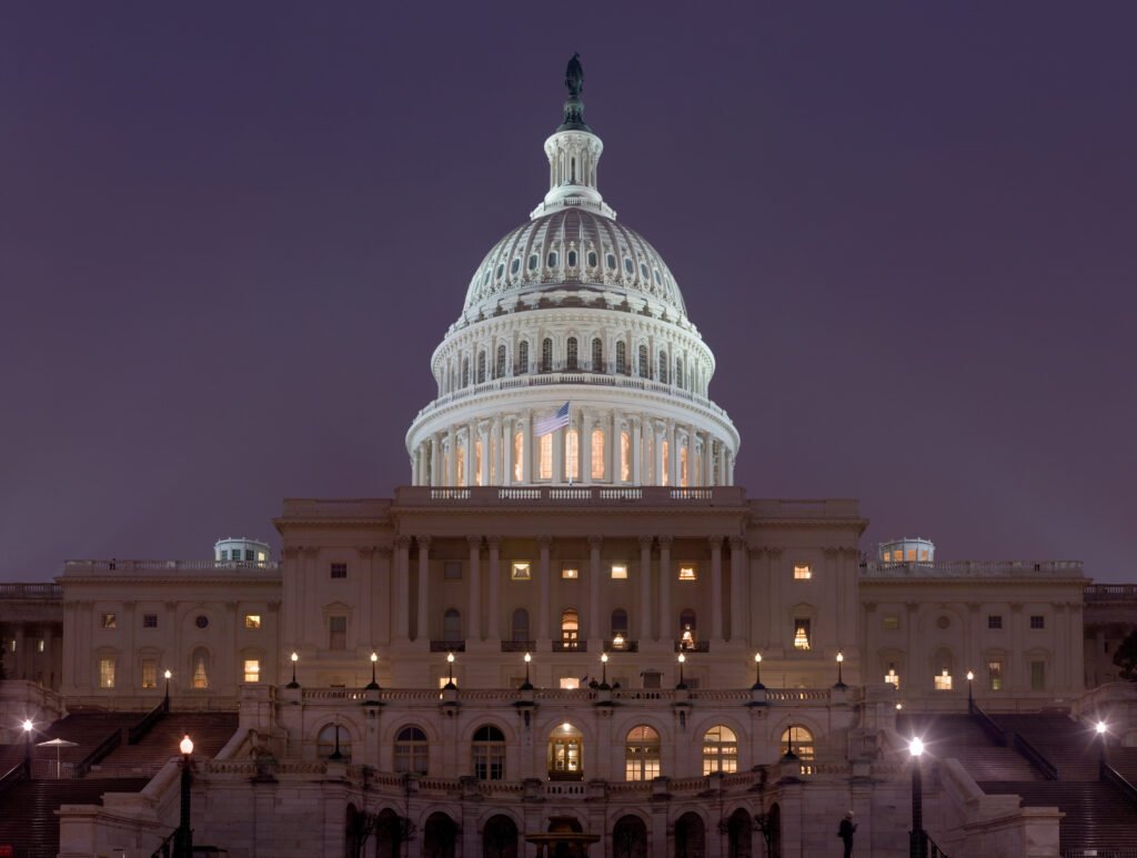 The United States Capitol building illuminated at night in Washington, DC