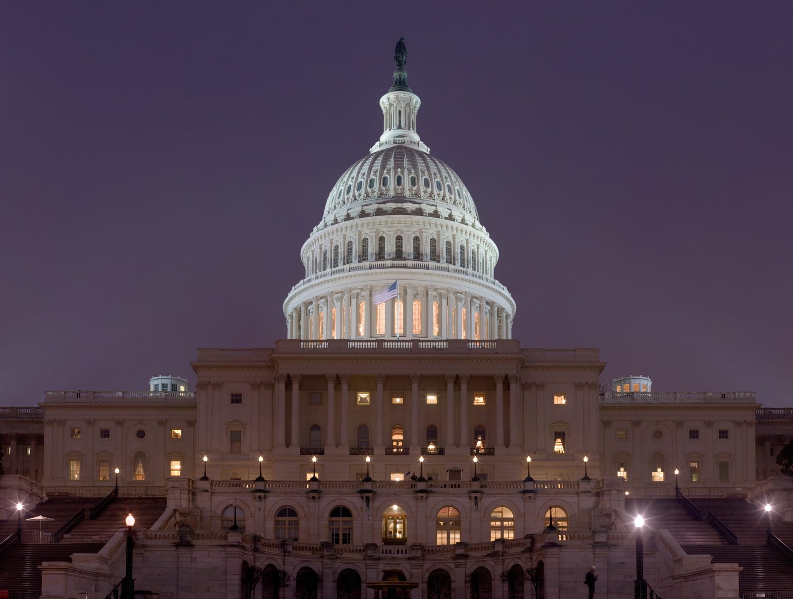 The United States Capitol building illuminated at night in Washington, DC